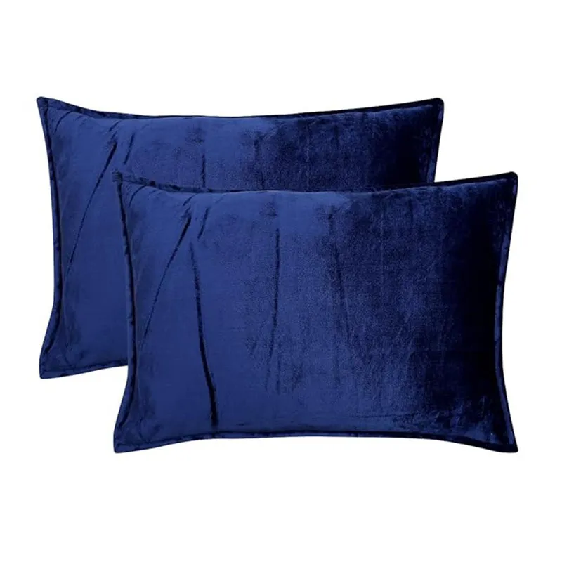 Two dark blue pillow covers on a plain white background