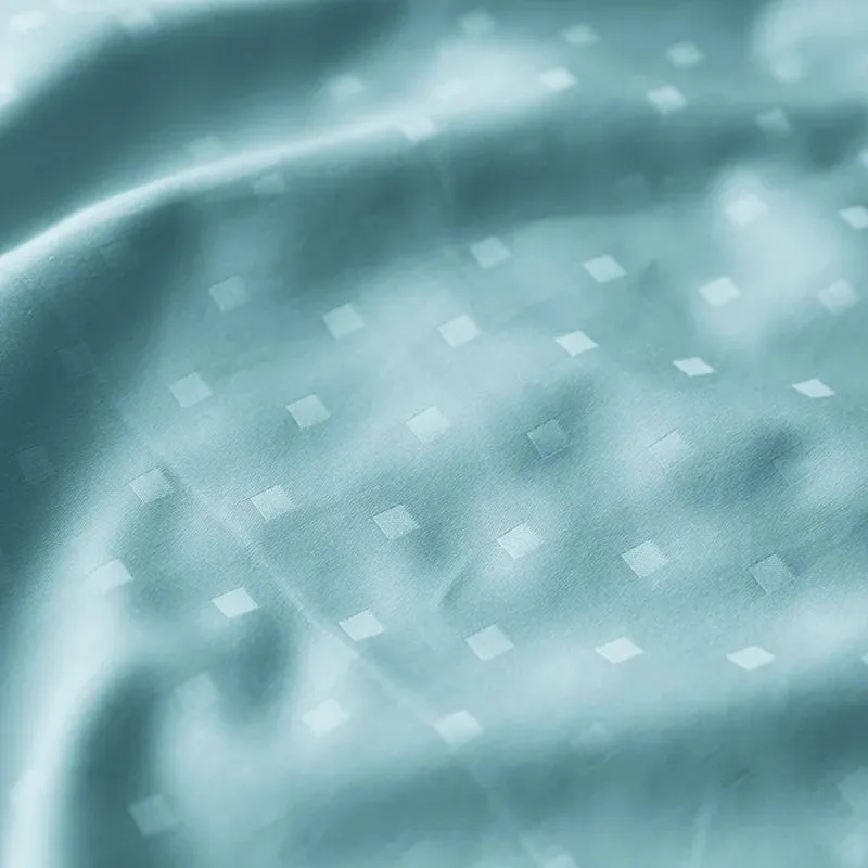 Close-up view of the smooth sky-blue fabric with white geometric dots