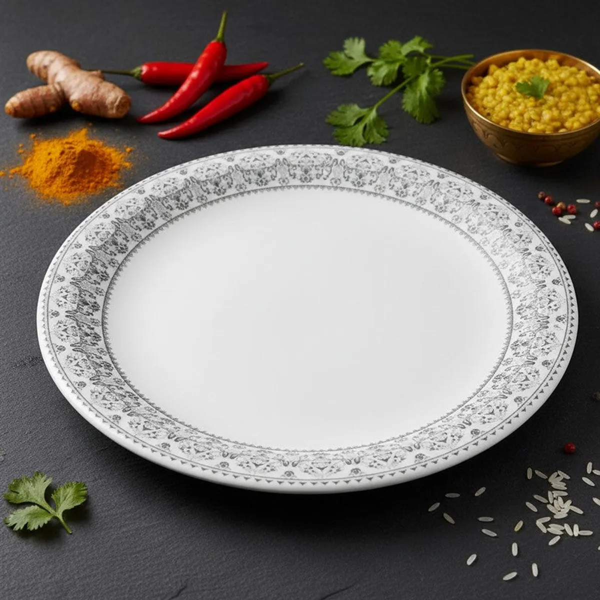 Single white quarter plate with an ornate grey border on a dark surface