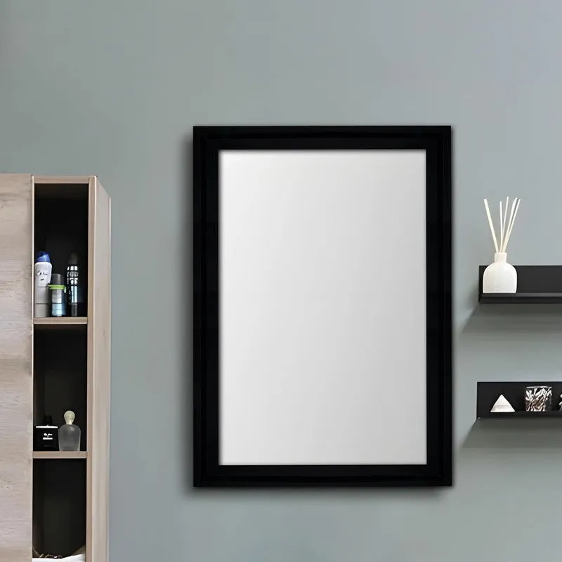Black rectangular wall mirror on a pale blue wall