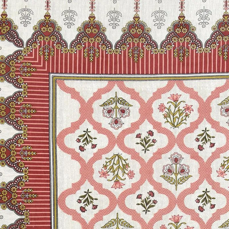 Close-up of peach floral and ethnic border pattern on the bedsheet