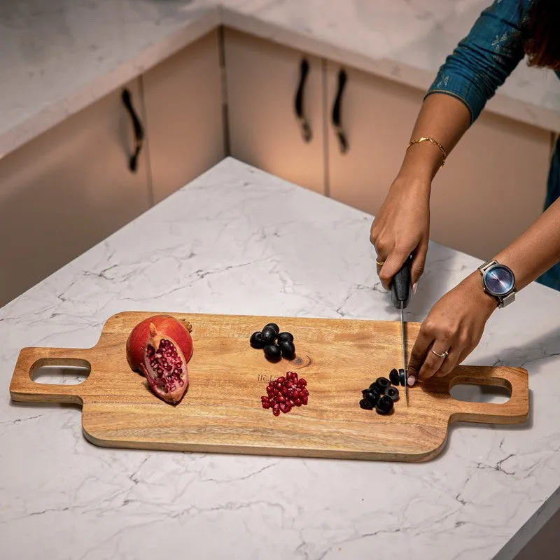 Person chopping fruit on a brown wooden board with double handles