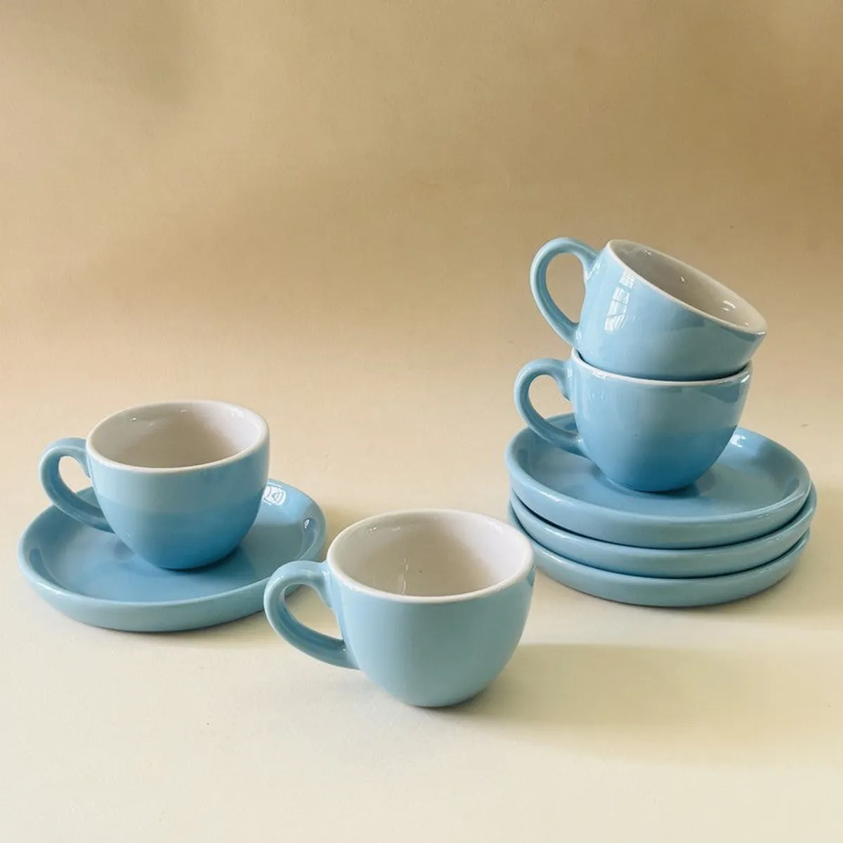 Blue ceramic cups and saucers shown in a stacked arrangement