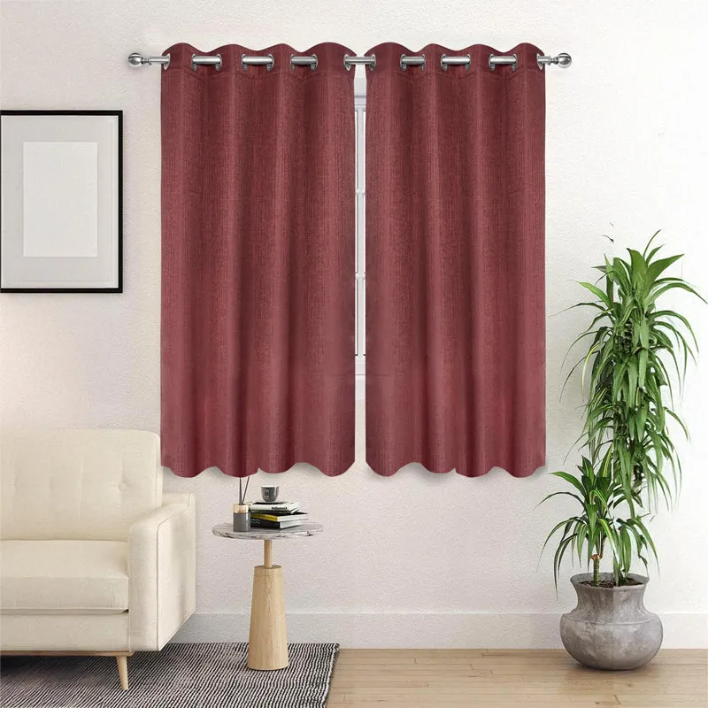 Mauve Auriel room-darkening curtain hanging from eyelets on a curtain rod