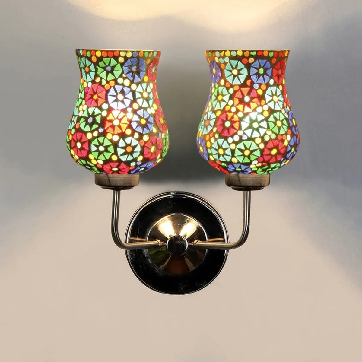 Front view of lit multicolour mosaic glass wall lamp
