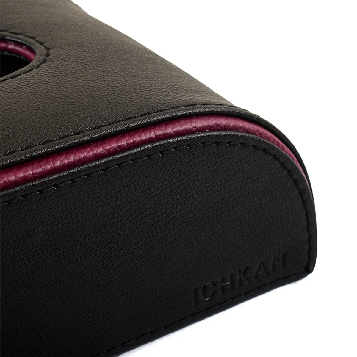 Close-up of the black textured finish and maroon trim on the tissue holder