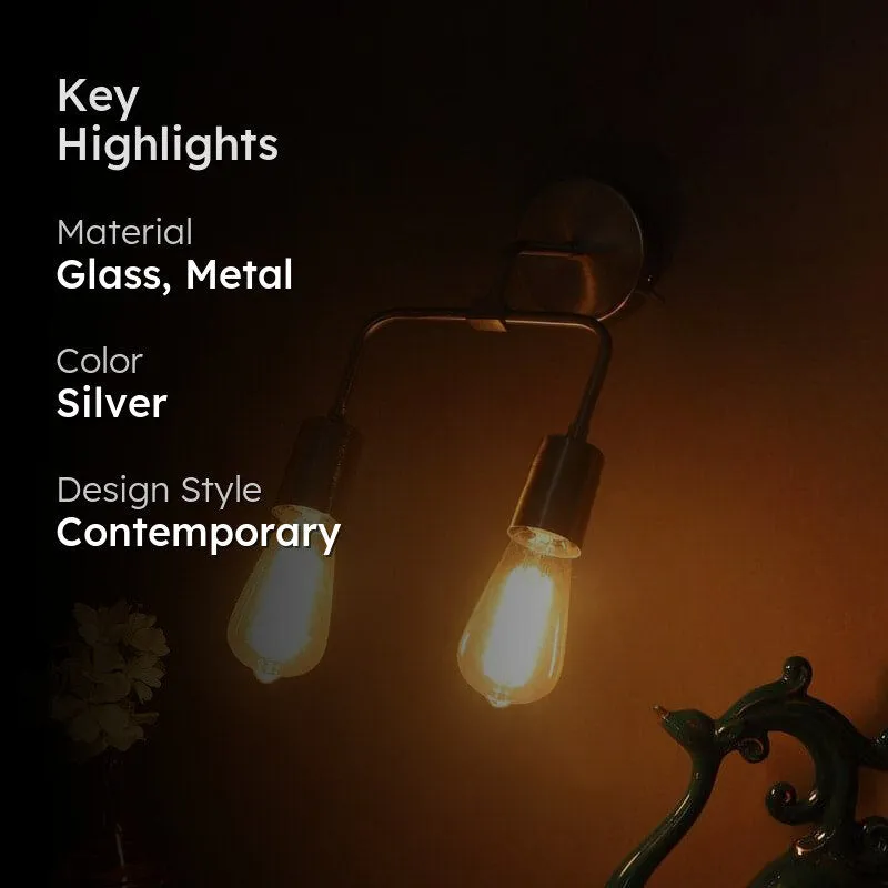 Silver wall lamp with glowing clear glass shades in a styled interior