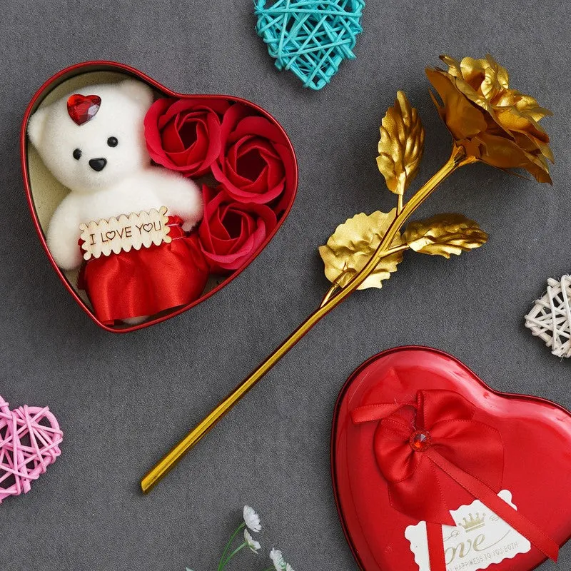 Open heart-shaped gift box with teddy and roses, with a gold rose stem
