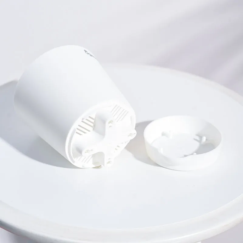 White plastic planter shown upside down beside its matching saucer