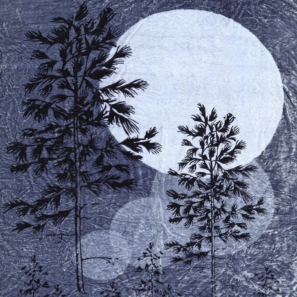 Close-up of blue blanket with dark trees and a large moon motif