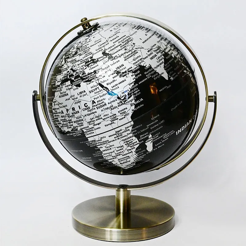 Black and white globe showpiece with a metallic stand against a plain white background