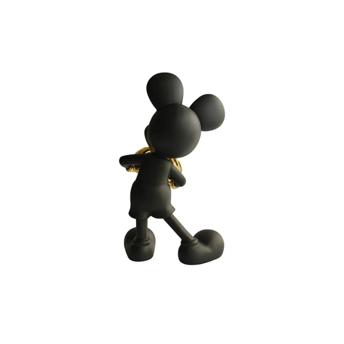 Rear view of the black figurine with gold gloves against a white background.