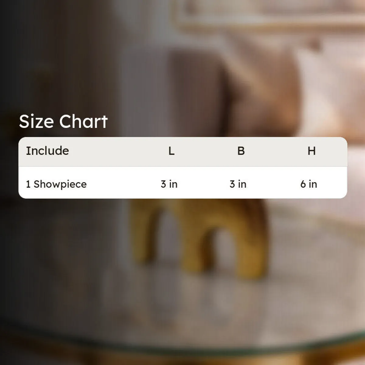 Size chart graphic for the gold elephant showpiece over a blurred room background