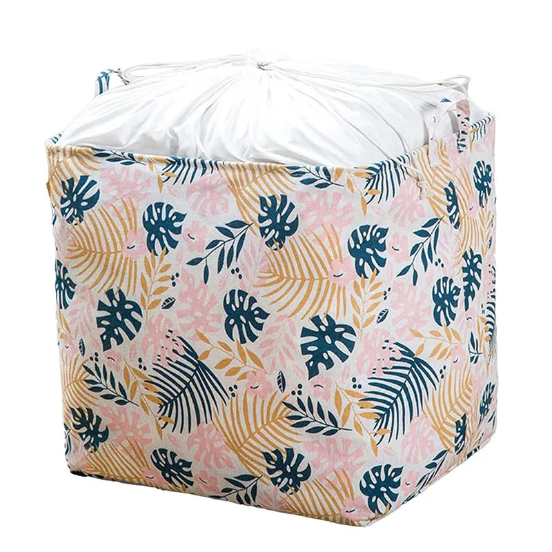 Pink botanical laundry basket with white drawstring top and handles