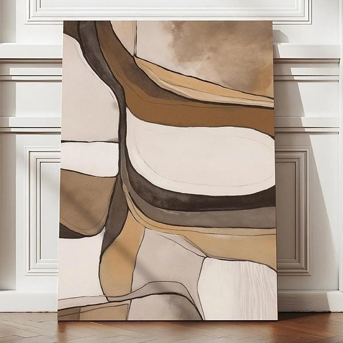Abstract beige and brown canvas wall art leaning against a panelled wall