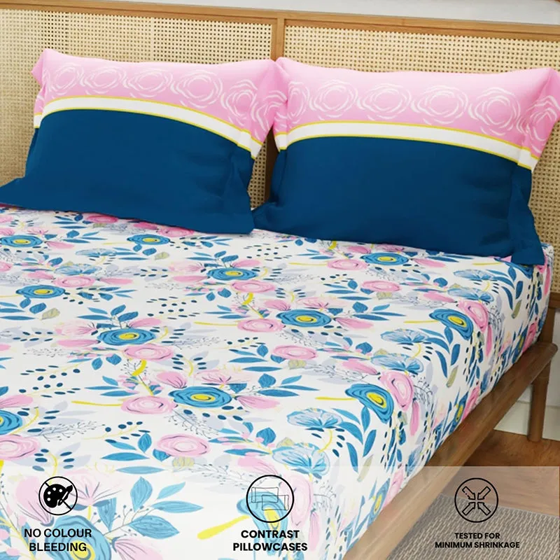 Floral bedsheet with blue contrast pillow covers on a bed