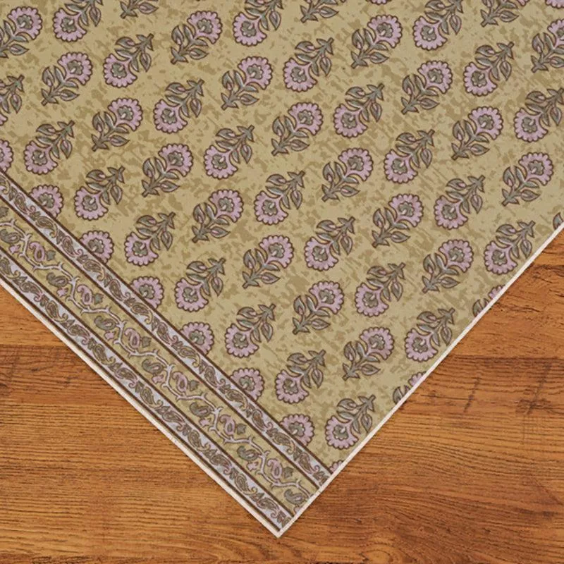 Corner view of the rectangular carpet with patterned border on wooden floor