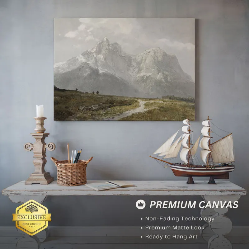 Mountain landscape wall art displayed above a console table with decor accents