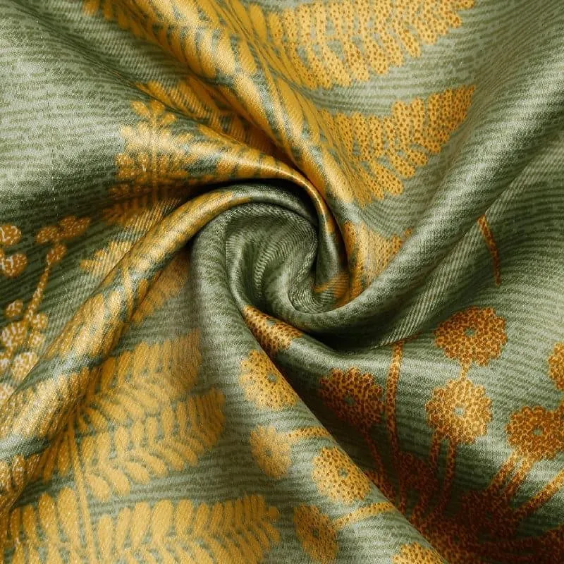 Close-up of green artificial silk curtain fabric with gold botanical print
