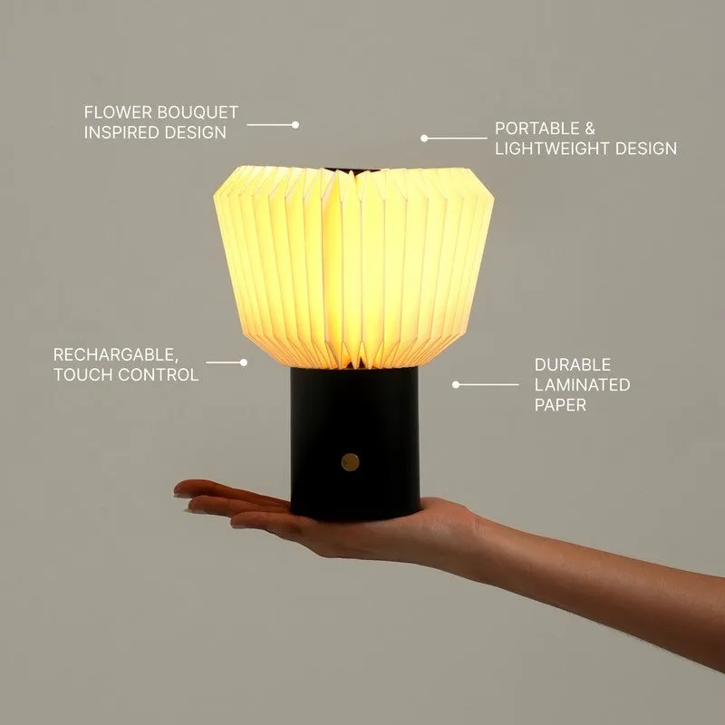 Illuminated pleated table lamp held in hand with feature callout lines