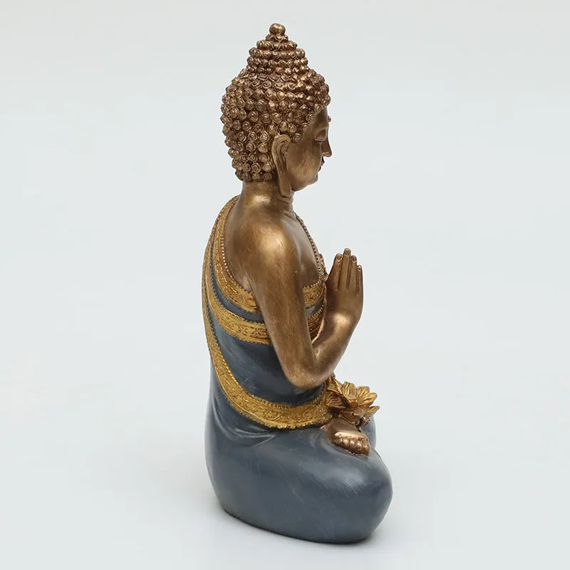 Side view of the seated Buddha idol with gold detailing