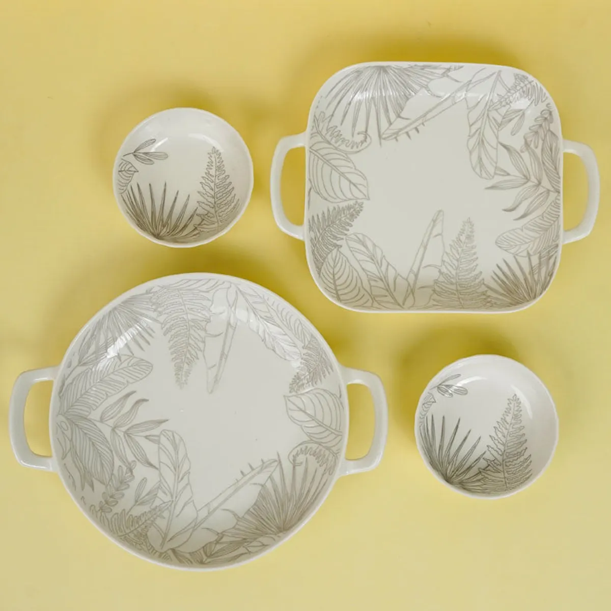 Top view of two bowls and two botanical platters in a porcelain serving set