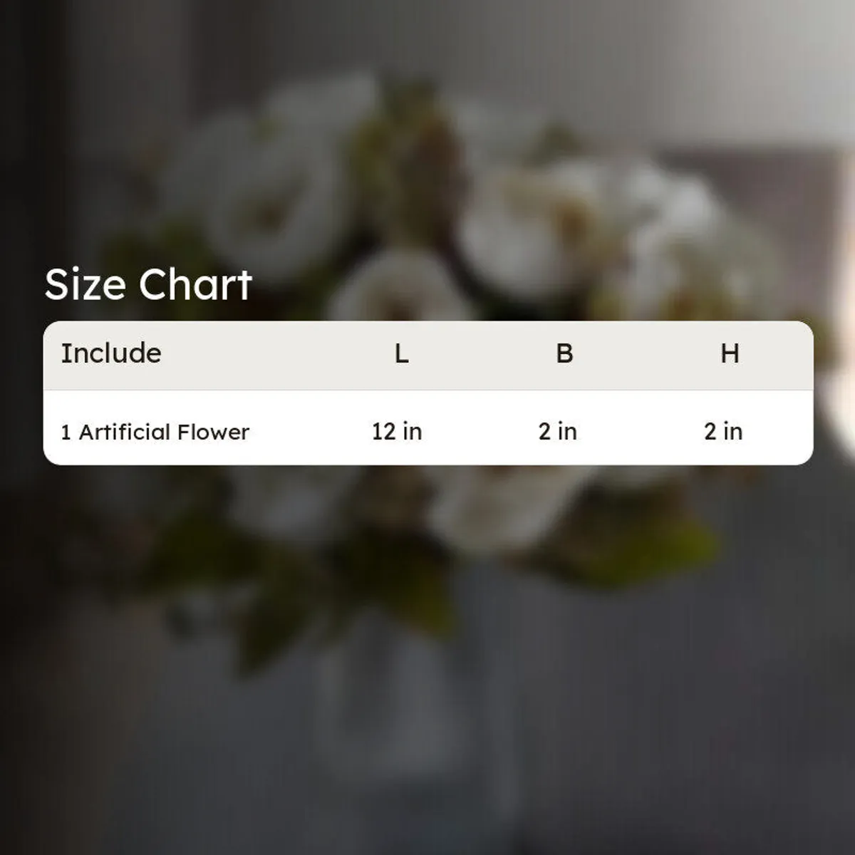 White artificial flower bouquet with green foliage shown in a vase