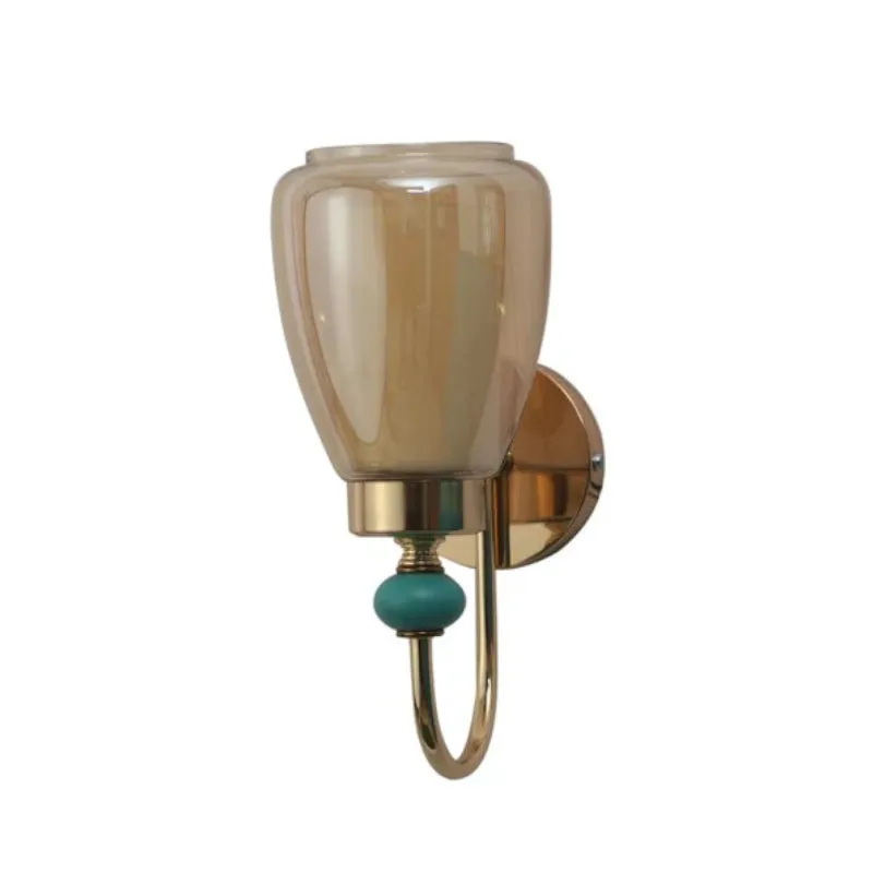 Gold-toned wall lamp with tinted glass shade and teal accent on a white background