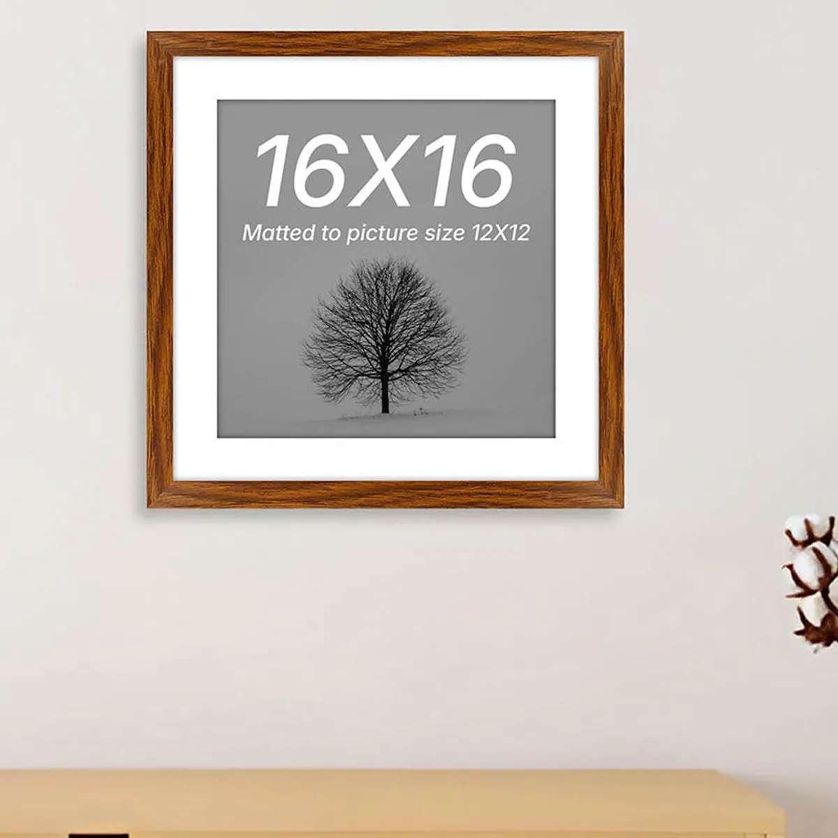 Brown wooden photo frame displayed above a console table in a neutral room.