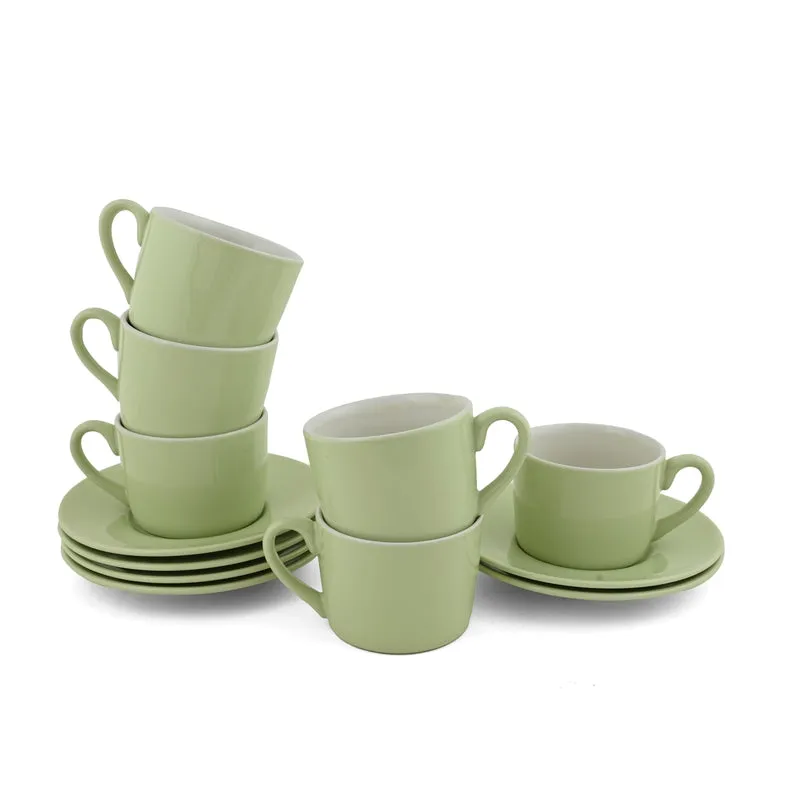 Six green cups and saucers arranged against a white background