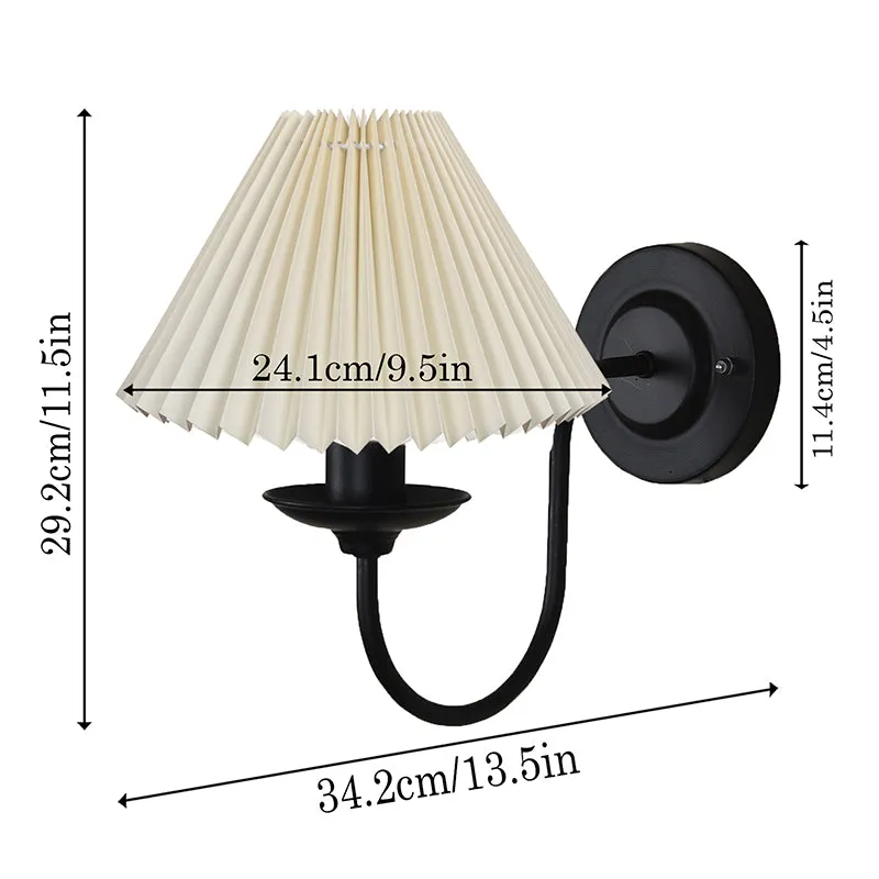 Ivory pleated wall lamp with black metal arm shown with dimension arrows on a white background