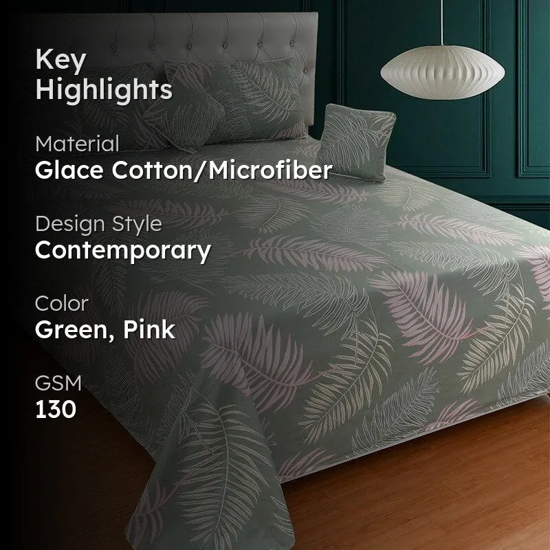 Green bedding set with leaf print displayed on a bed
