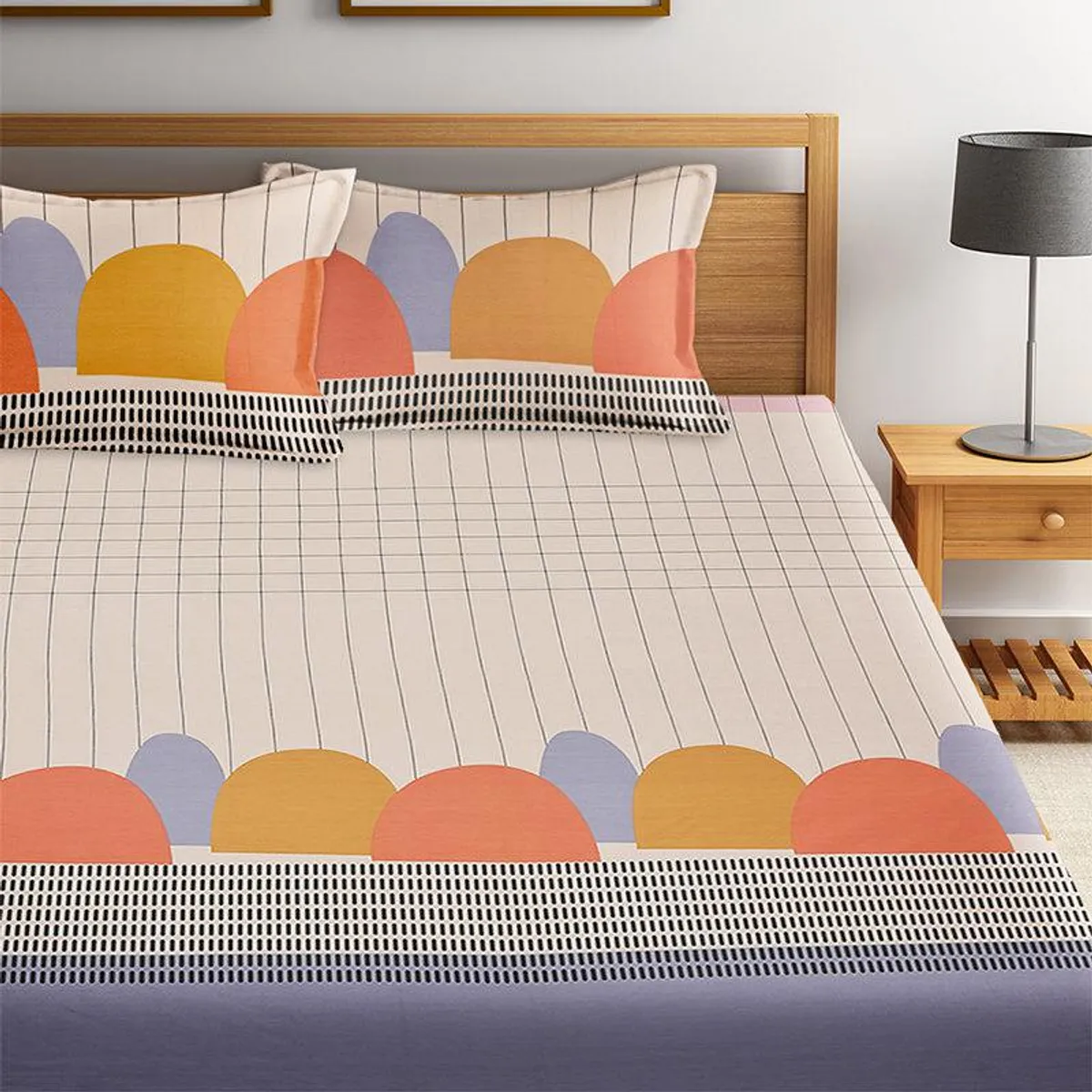 Close view of geometric bedsheet border with colourful arches and grid pattern