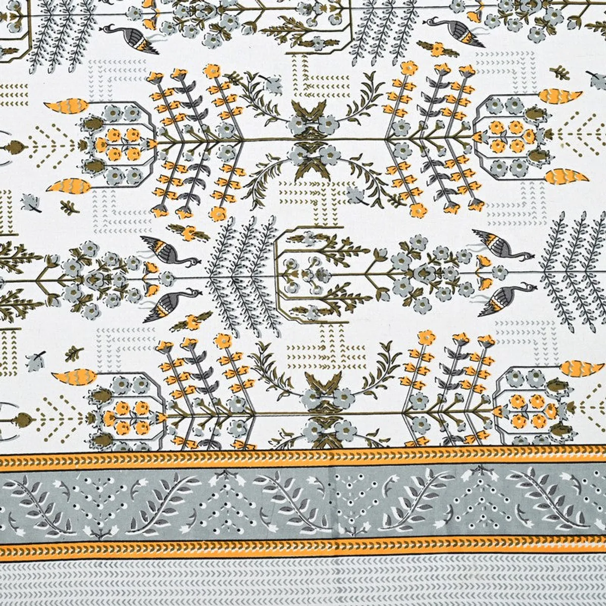 Close-up of the bedsheet's floral pattern and decorative border