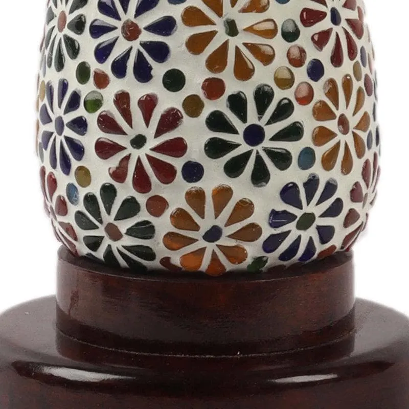 Close-up of floral mosaic glass shade and dark wood base