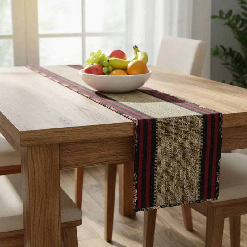 Maroon and black table runner placed on a dining table with a fruit bowl
