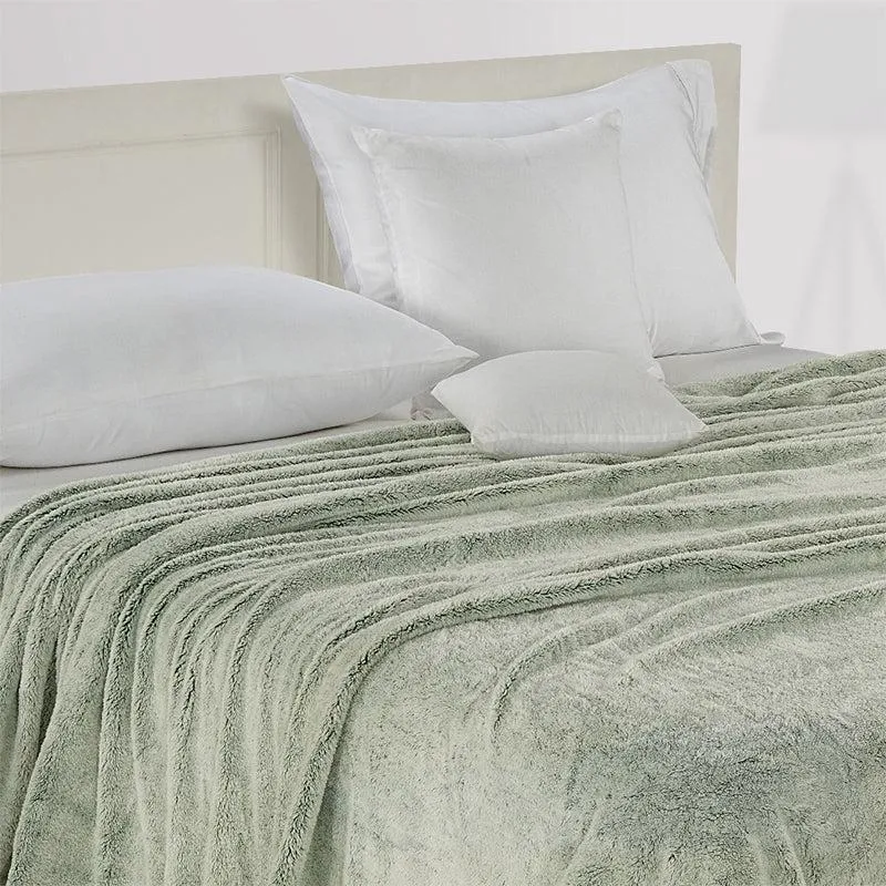 Closer view of the green dohar draped across a bed