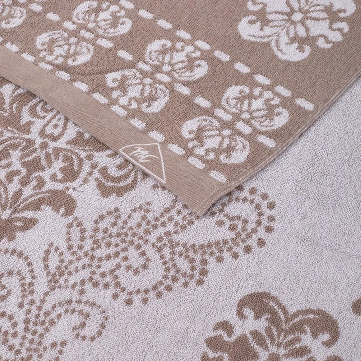 Close-up of beige and off-white floral towel border and texture