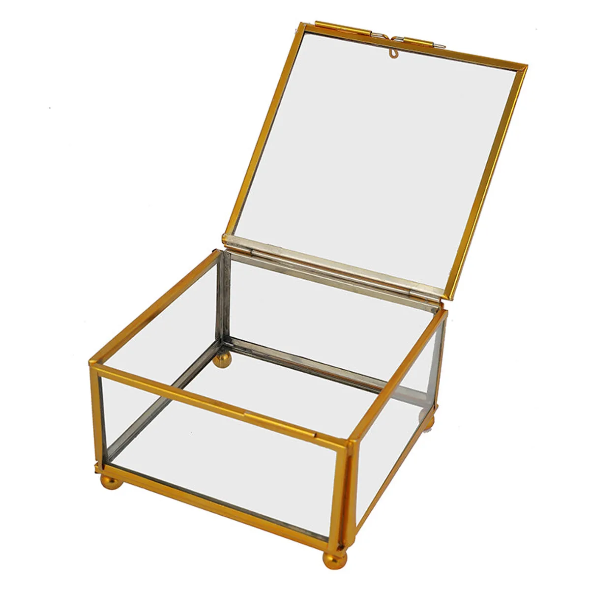 Open transparent glass jewel box with a gold frame and round feet