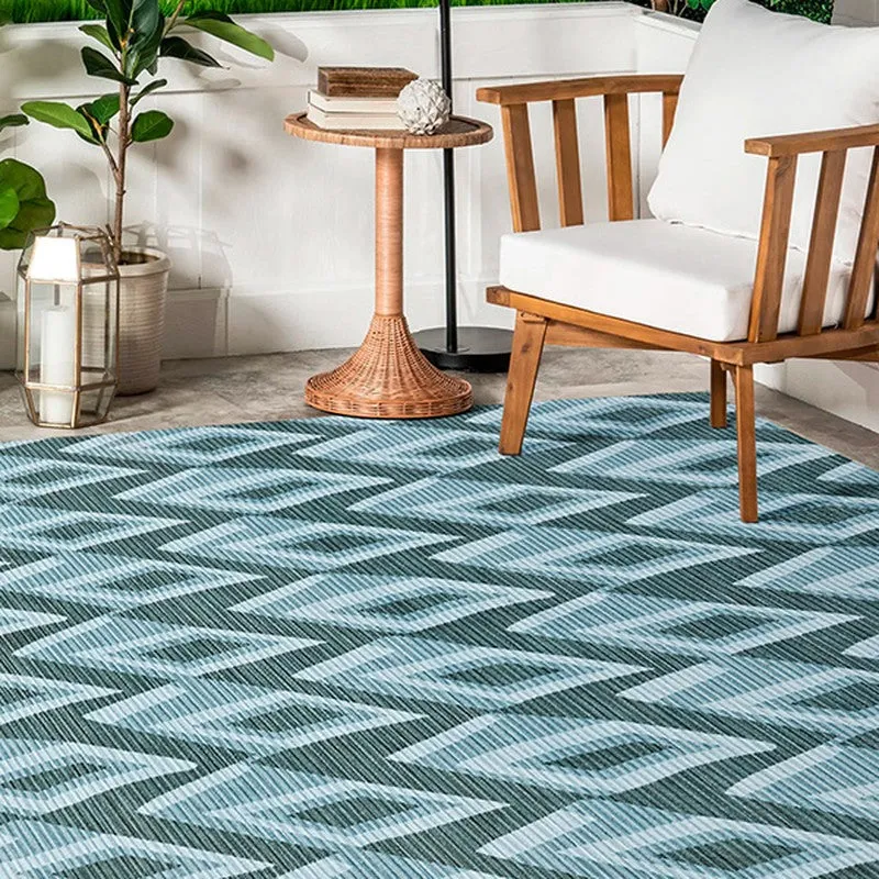 Blue patterned carpet placed beside a wooden lounge chair
