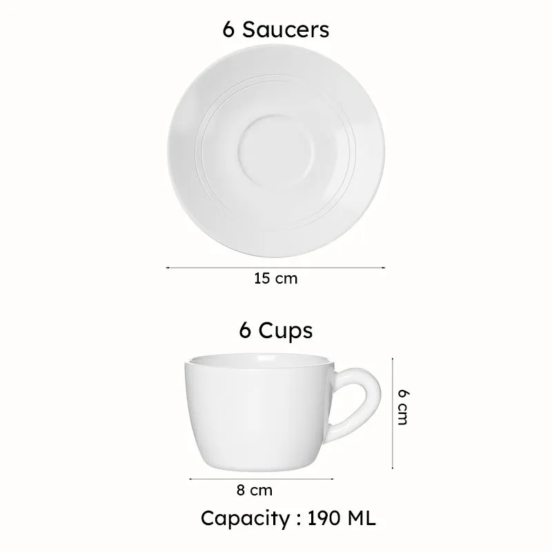 Green cup and saucer set styled on a table beside vases and flowers