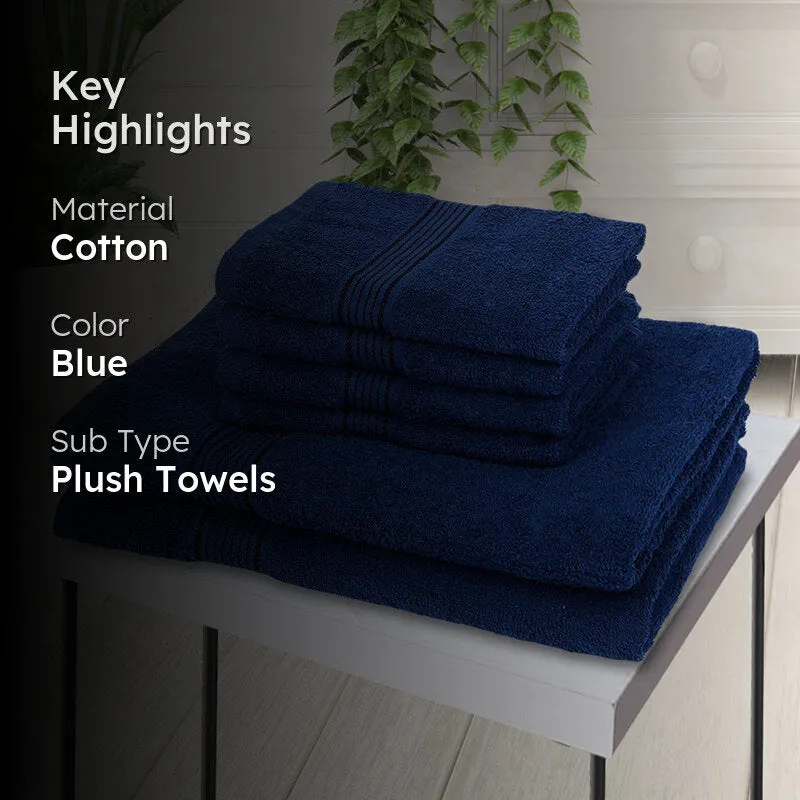 Navy blue towel set displayed on a table in a bathroom setting