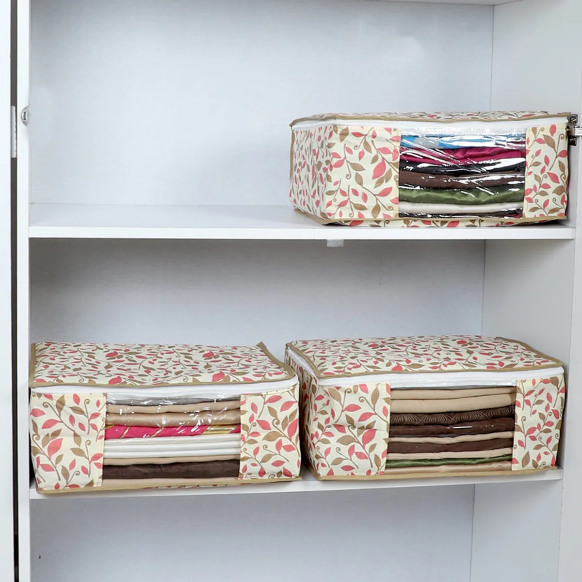 Three floral cloth organisers arranged on wardrobe shelves