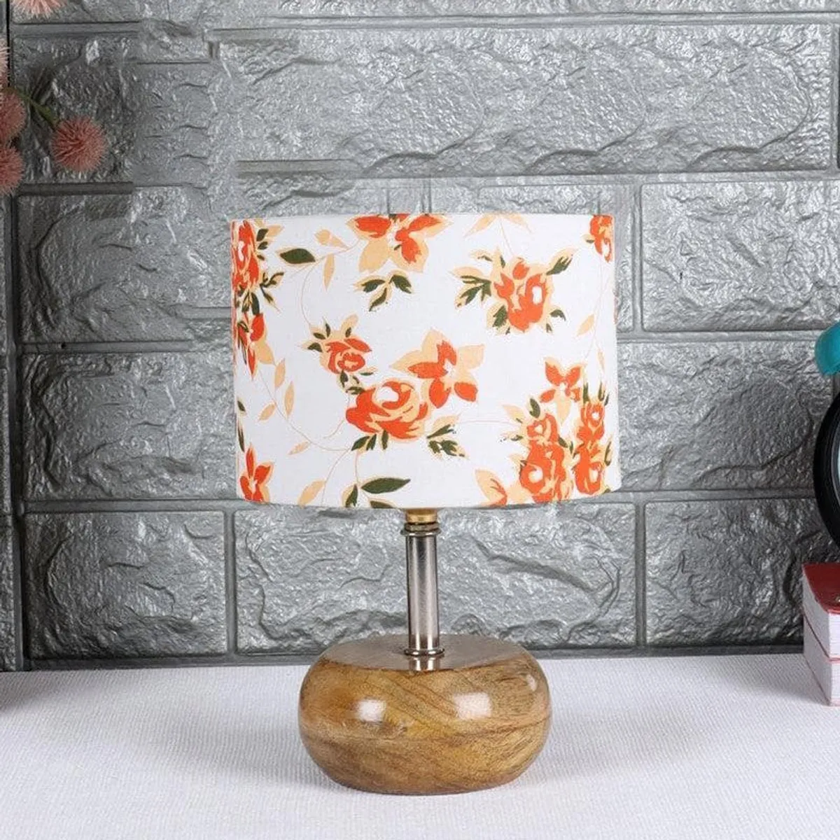 Table lamp with floral fabric shade and rounded wooden base