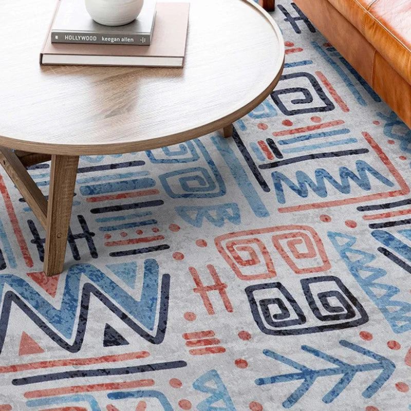 Close view of the carpet under a round table showing abstract geometric motifs