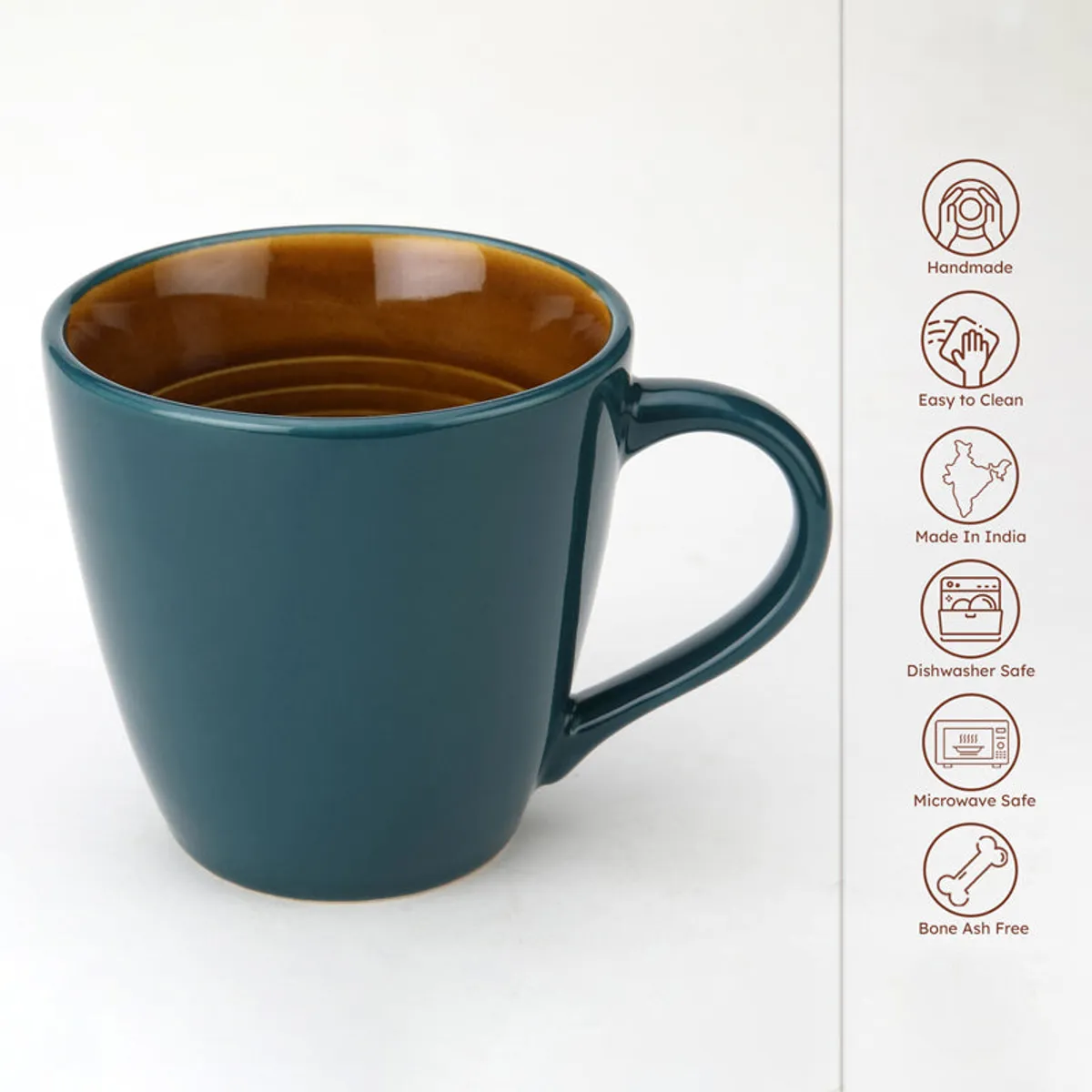 Blue ceramic mug shown close-up with a brown glazed interior