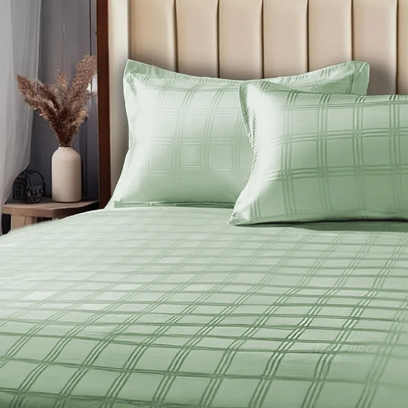 Close view of sage green checked bedsheet with matching pillow covers
