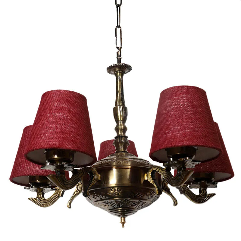 Low angle view of chandelier with maroon textured shades and antique gold body