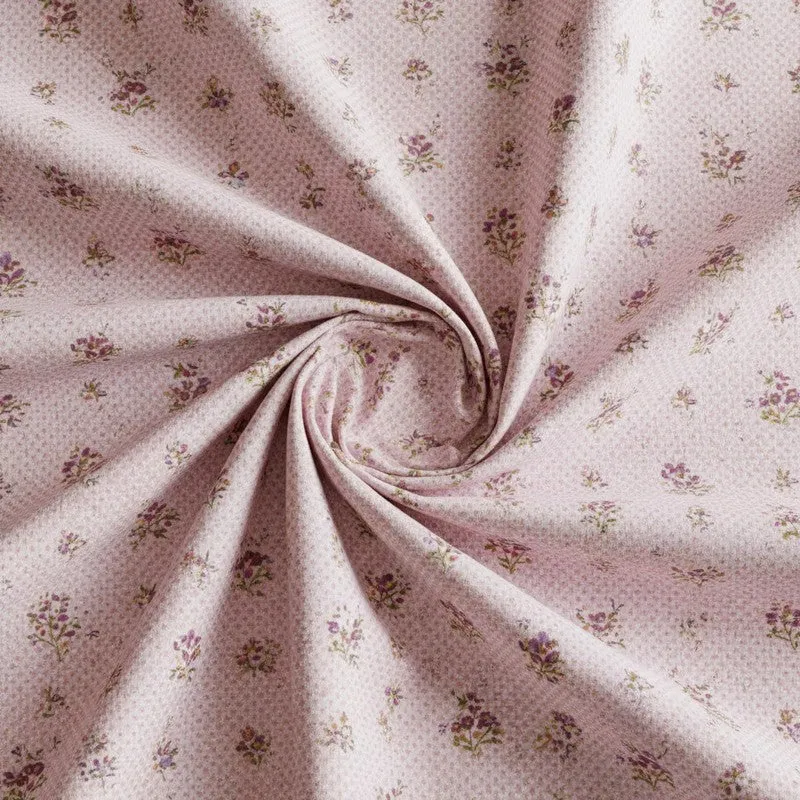 Close-up of pink cotton fabric with small floral print