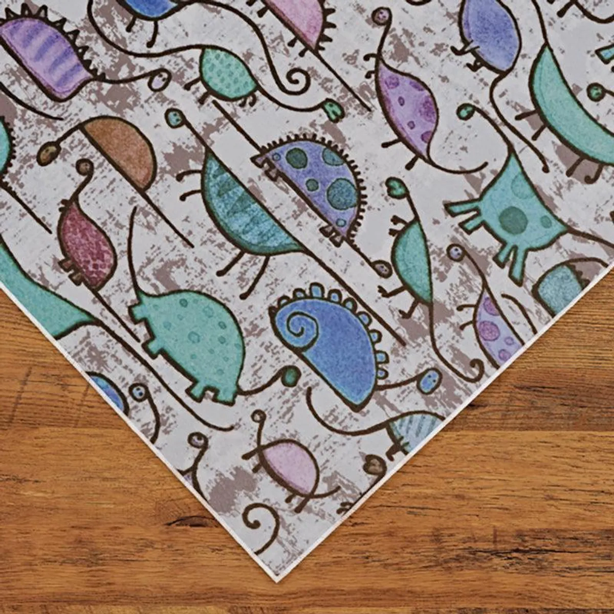 Angled view of the dinosaur pattern carpet on wooden flooring